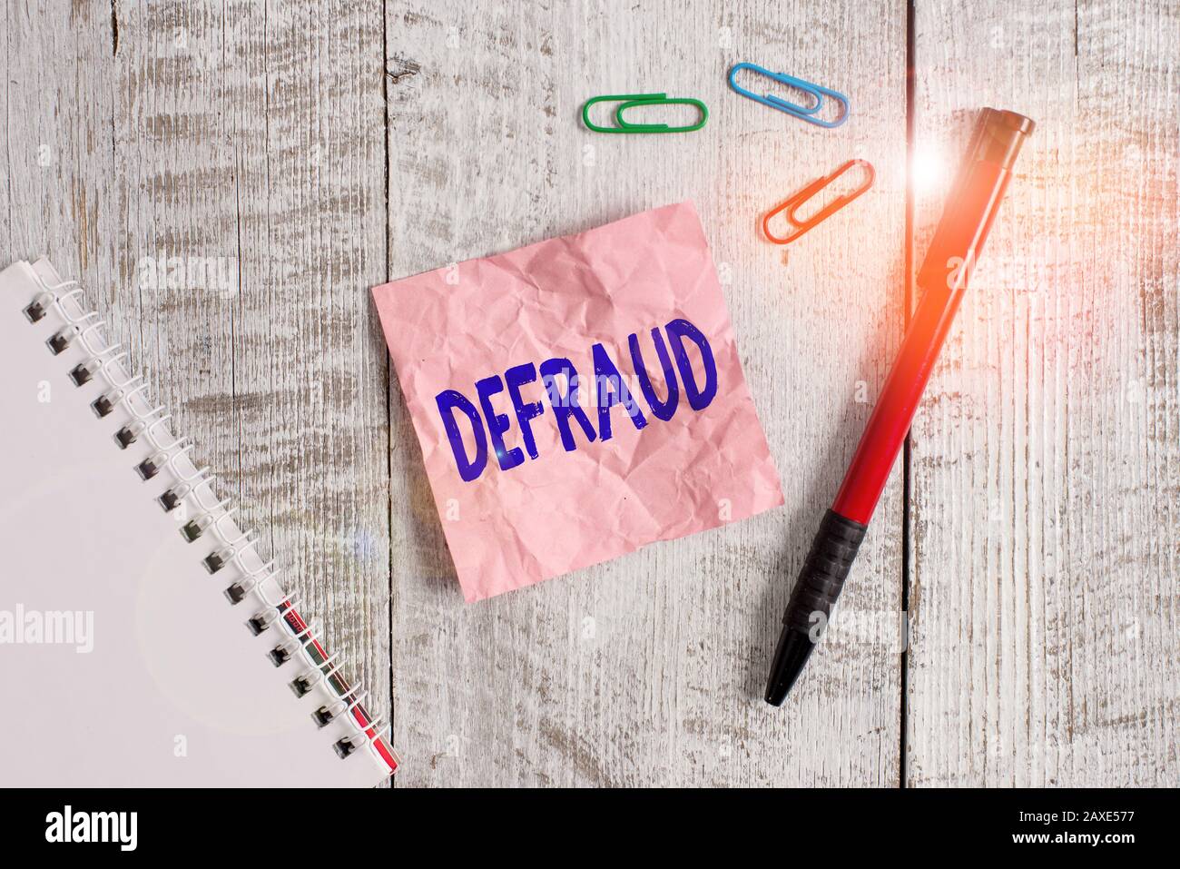 Word writing text Defraud. Business photo showcasing to trick or cheat  someone or something in order to get money Wrinkle paper and notebook plus  stat Stock Photo - Alamy