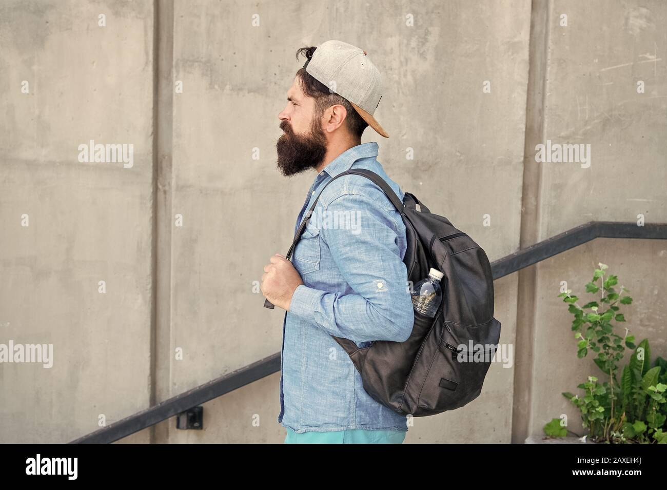 Feed your wanderlust. Mature hipster with beard traveller. Bearded man. Confident brutal man walk street. Male barber care. brutal hipster with travel backpack. hiking adventure concept. urban style S...