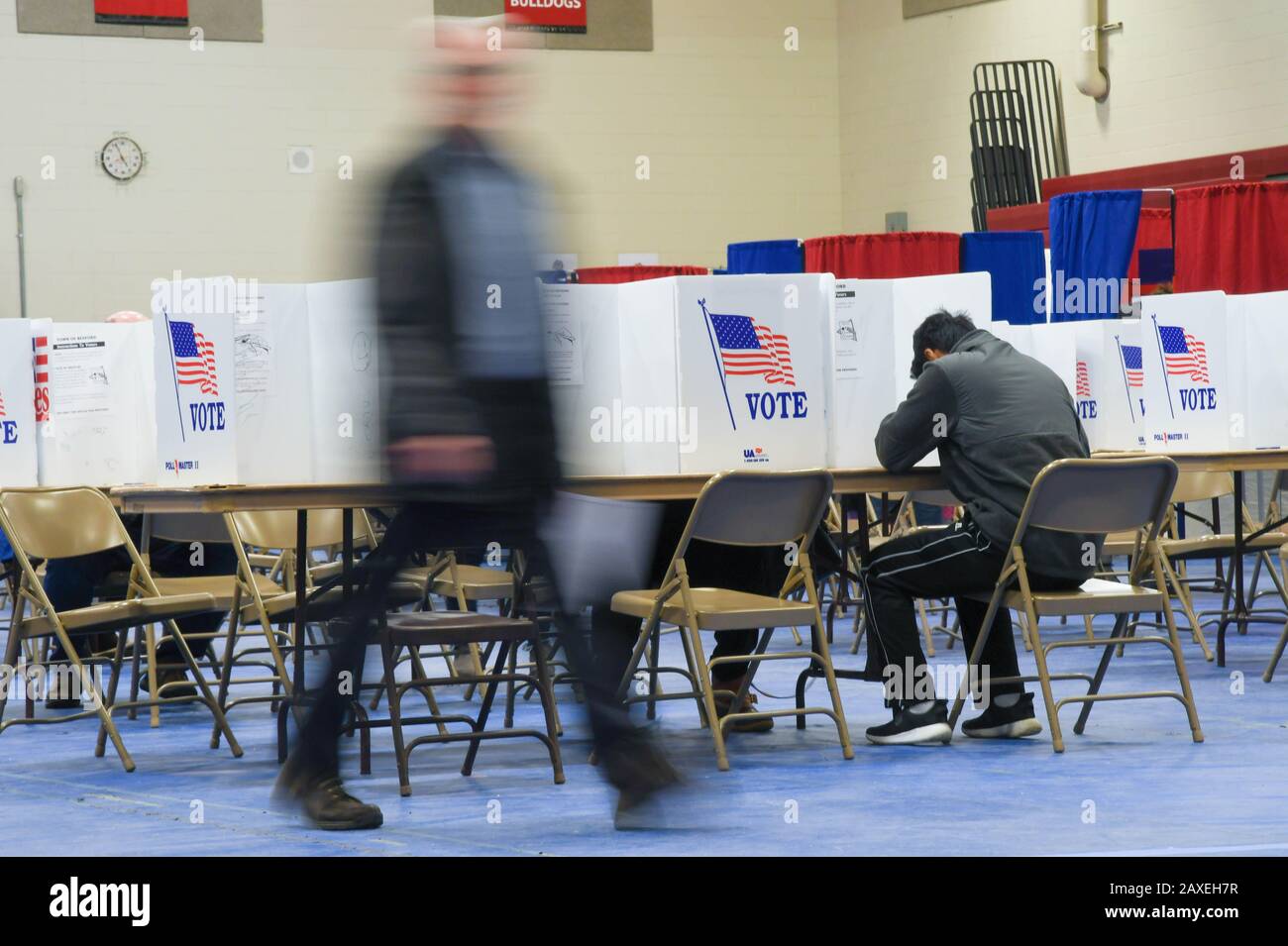 Voters cast ballots in Bedford, N.H., USA, during the New Hampshire presidential primary, 11 Feb., 2020. Stock Photo
