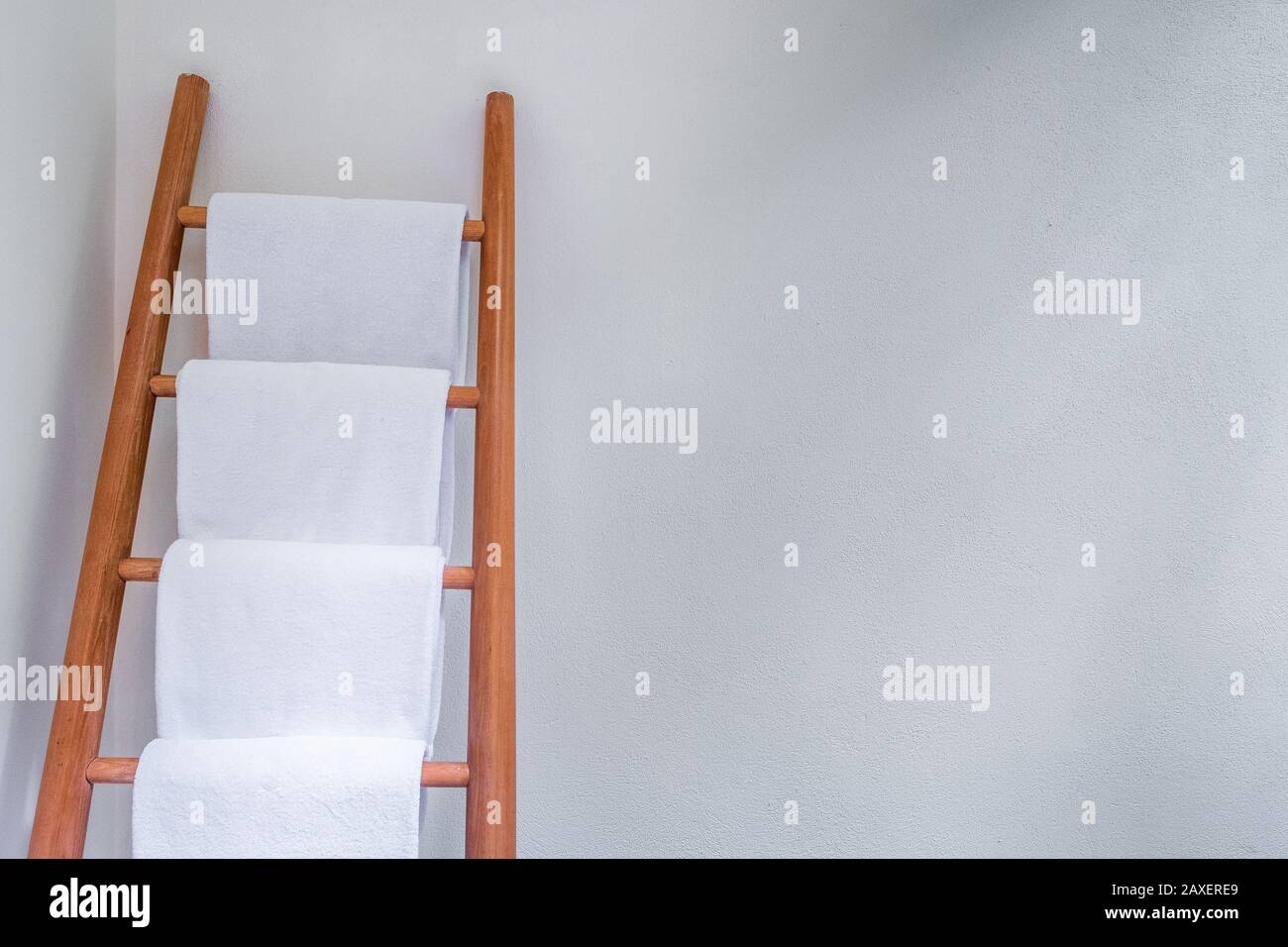 White bath towels on a ladder against a white room Stock Photo Alamy