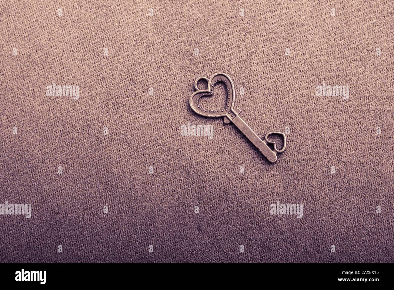 Heart shaped retro metal key on plain background Stock Photo - Alamy