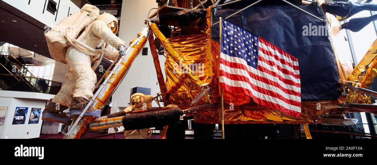 Low angle view of an astronaut and an American flag in a museum, National Air And Space Museum, Washington DC, USA Stock Photo