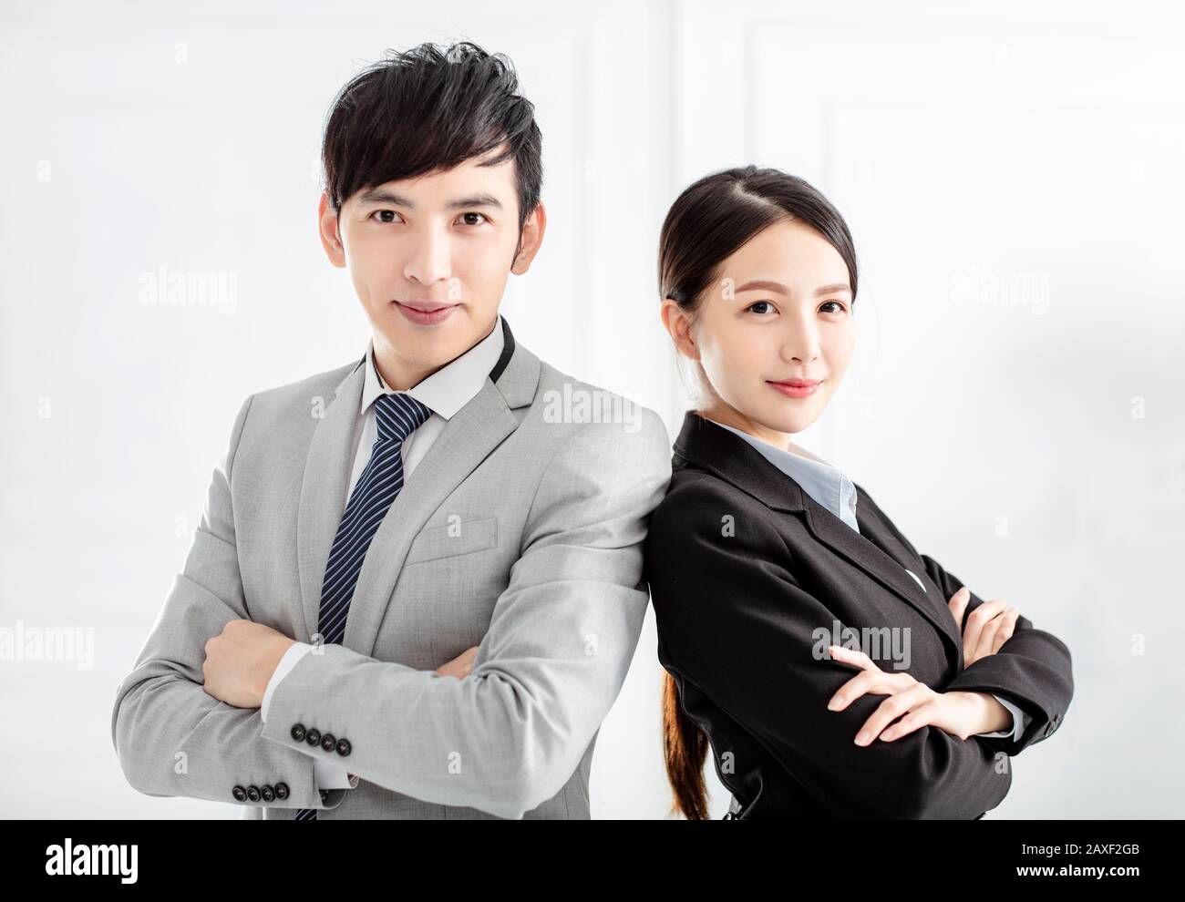 Young smiling business woman and business man Stock Photo - Alamy