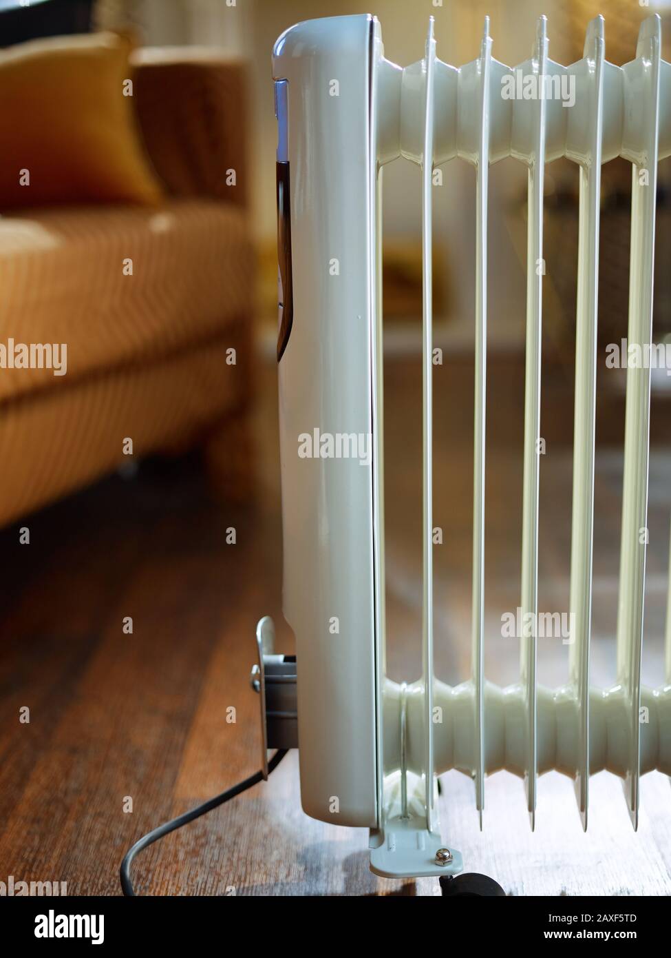 modern floor white electric oil radiator and in the modern house in sunny winter day. Stock Photo