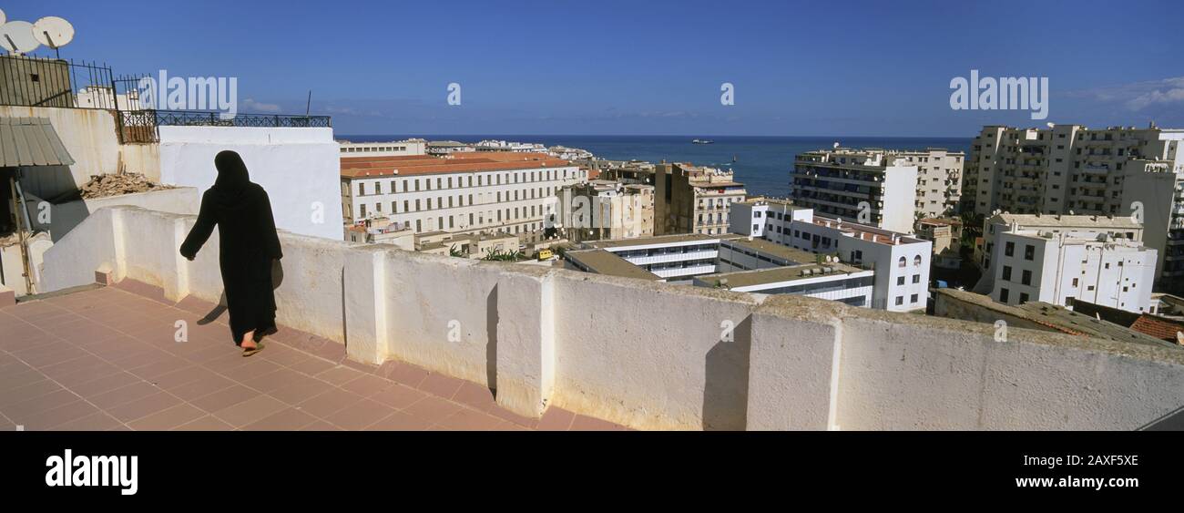 Rear view of a woman walking on the roof, Algiers, Algeria Stock Photo