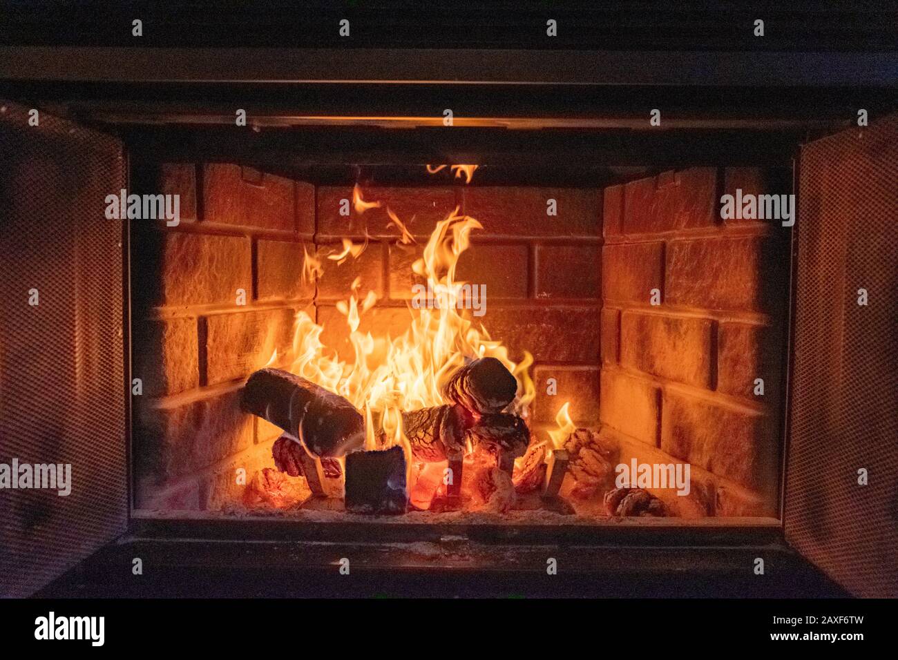 Closeup shot of a fire in a brick fireplace Stock Photo