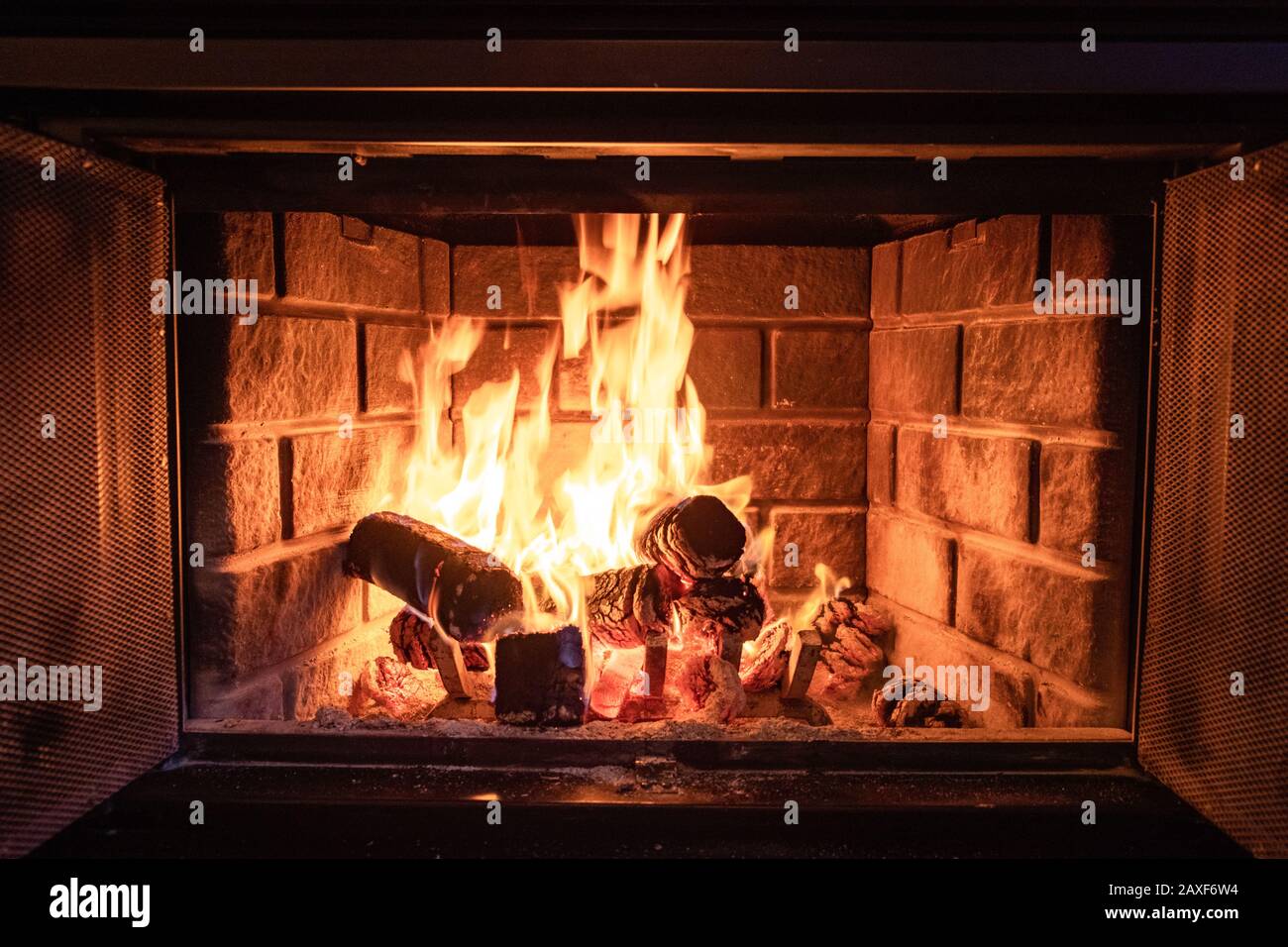 Closeup shot of a fire in a brick fireplace Stock Photo