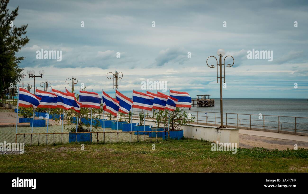 Many flags on poles in a seaside park in Prak nam pran Thailand Stock Photo