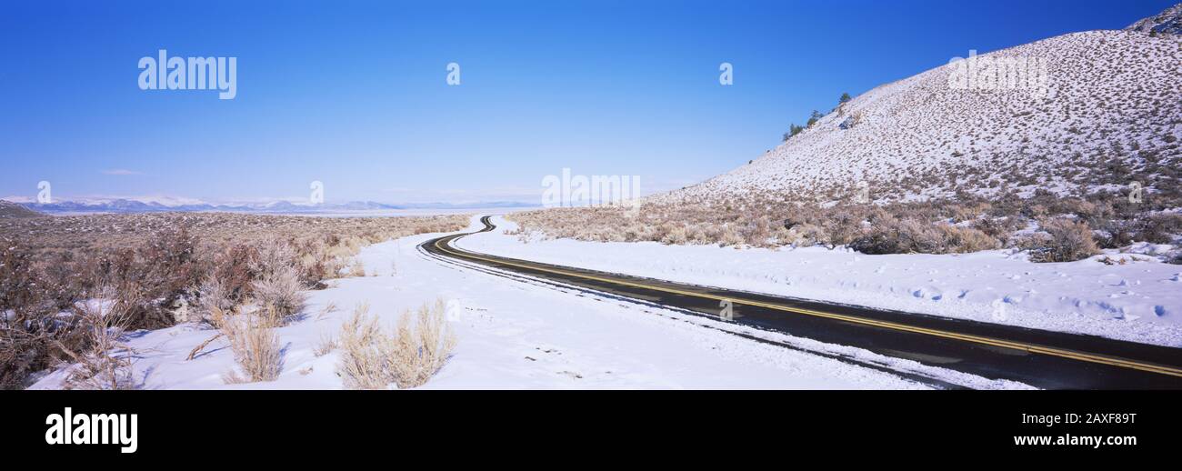 Road passing through snow covered landscape, Highway 120, California, USA Stock Photo