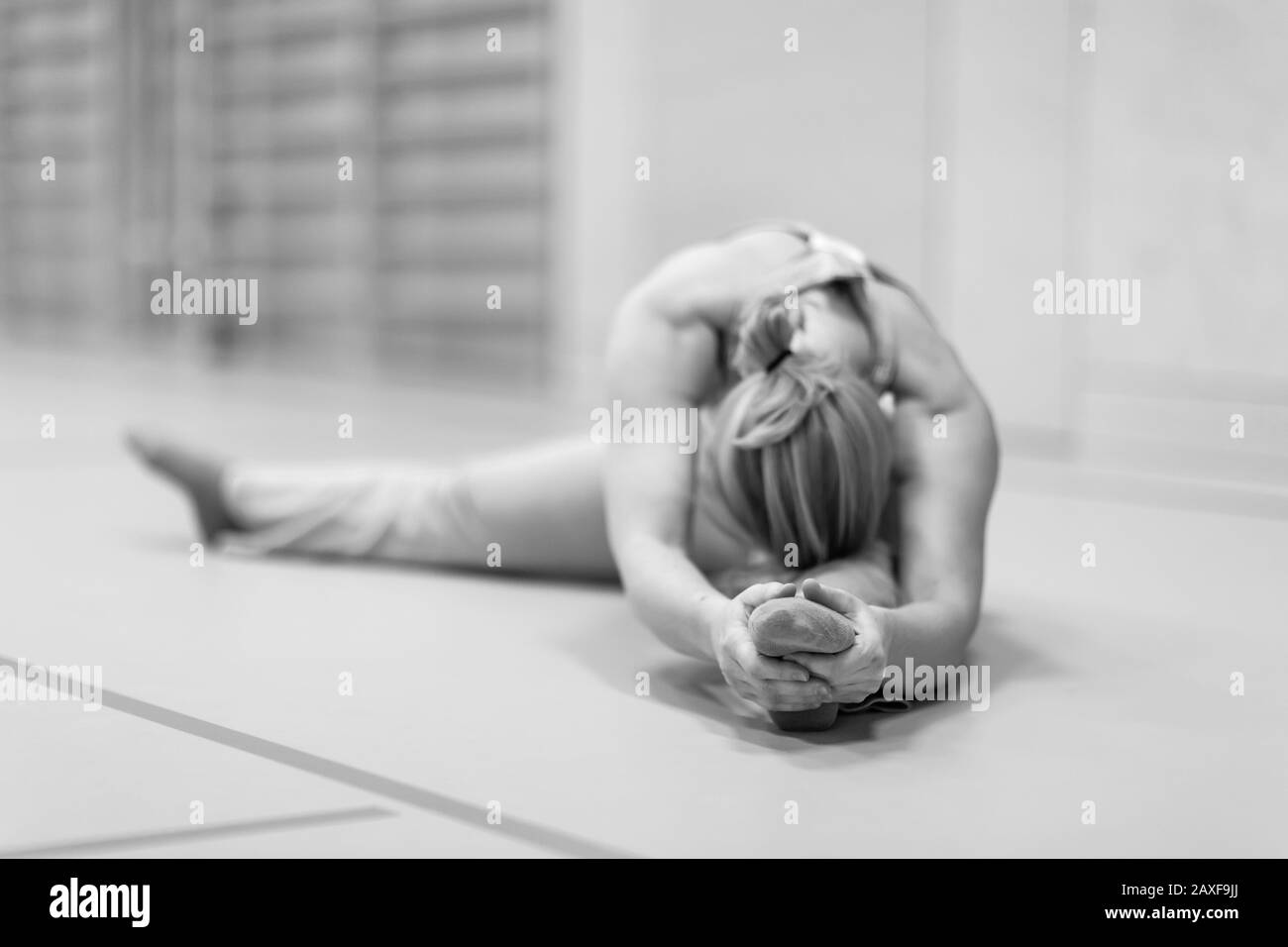 Selective focus shot of a woman having a flexible stretch Stock Photo