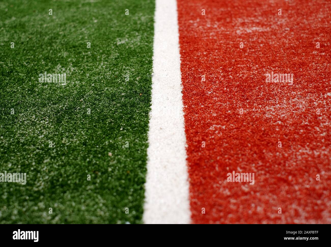 White line on green and red artificial turf, sand infill, selective view perspective Stock Photo