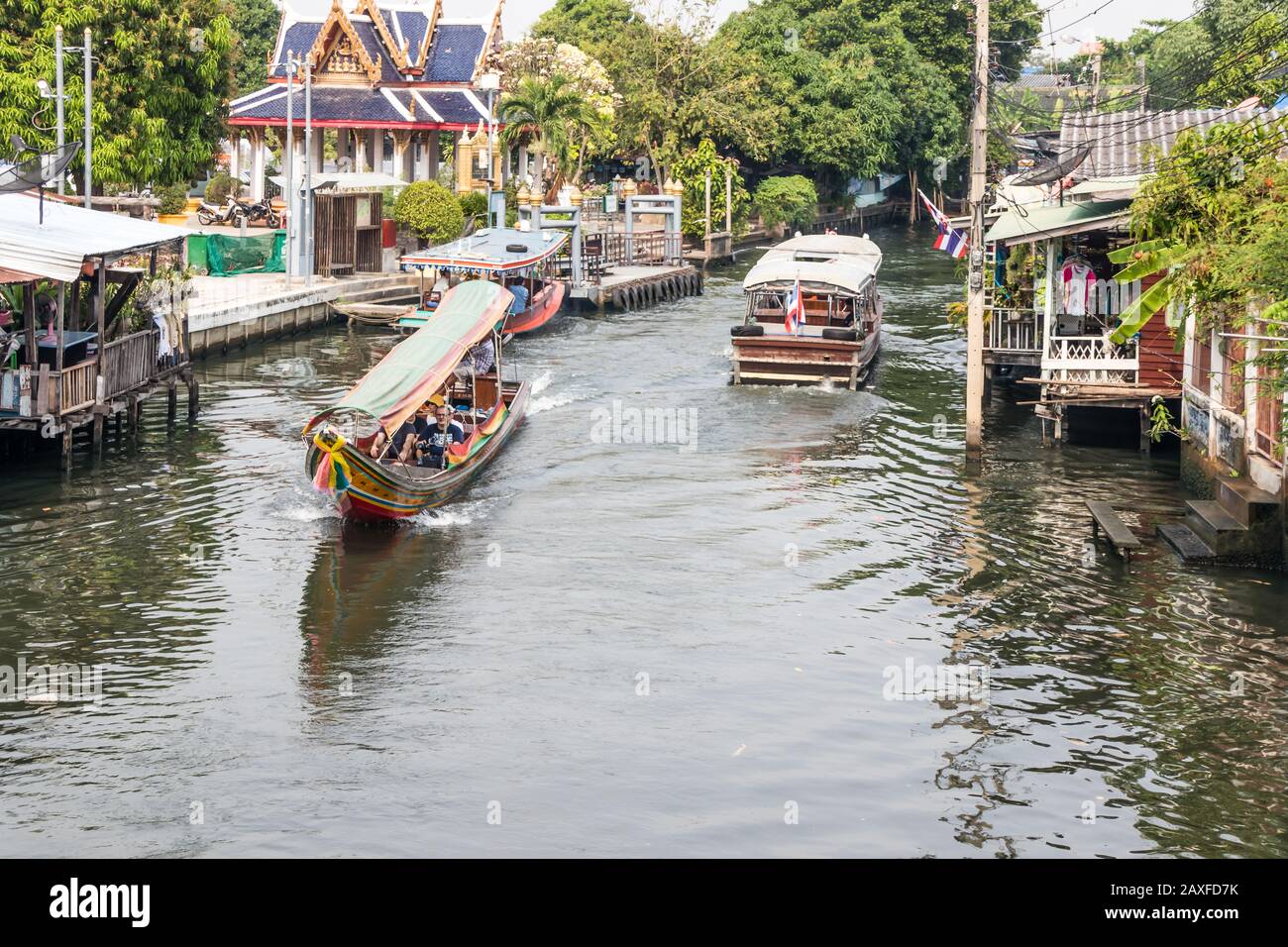 Bangkok, Thailand - January 11th 2020: Tourists boats on the canal at Khlong Bang Luang Floating Market. The area is a popular tourist attraction. Stock Photo