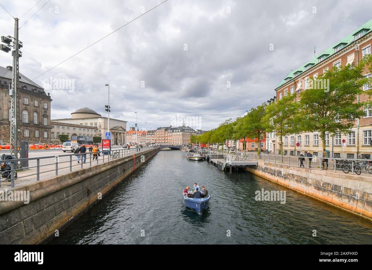 A group of people cruise a river canal in the urban center of Copenhagen, Denmark. Stock Photo