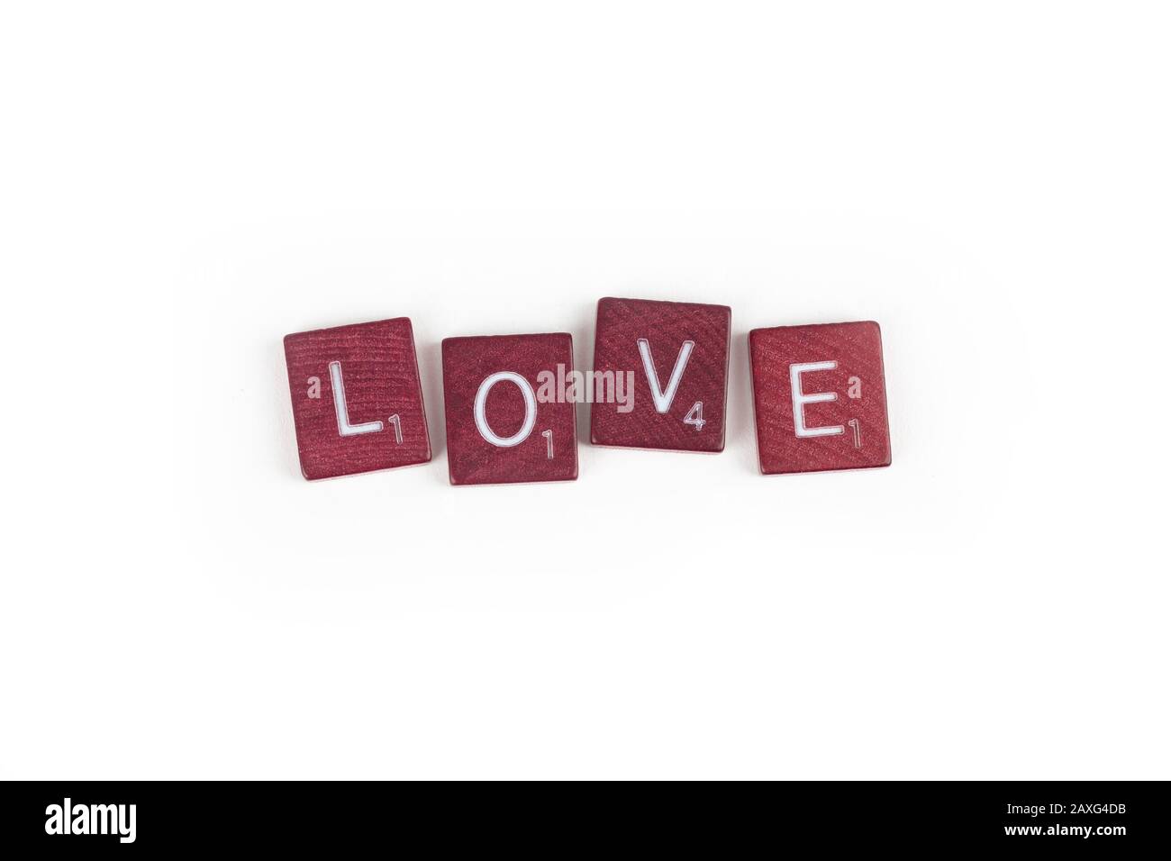 The word love spelled out in an uneven arrangement of game letter tiles. Stock Photo