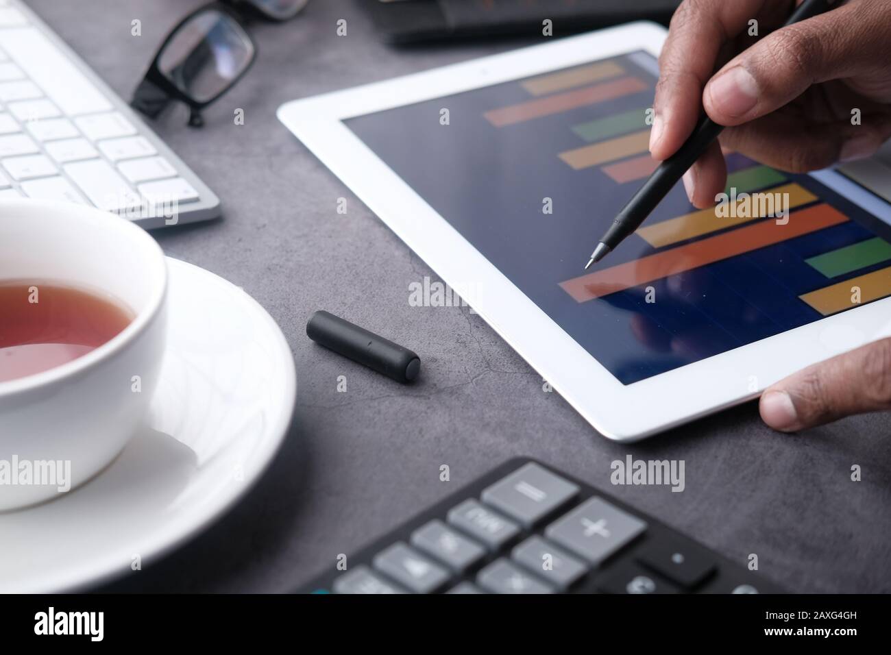 man hand analyzing financial chart on digital tablet  Stock Photo