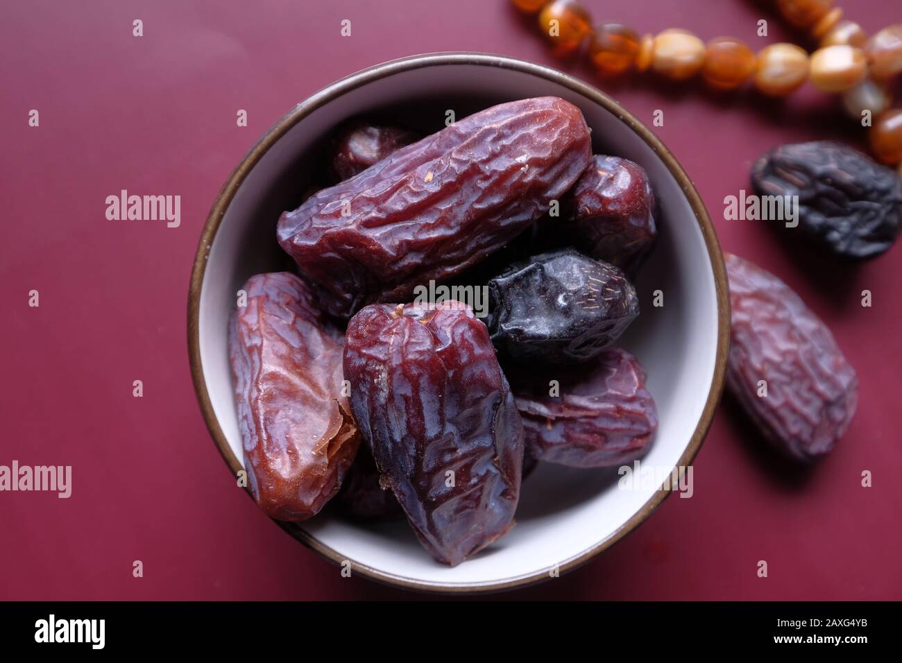 Close up of date fruit in a bowl on color background Stock Photo