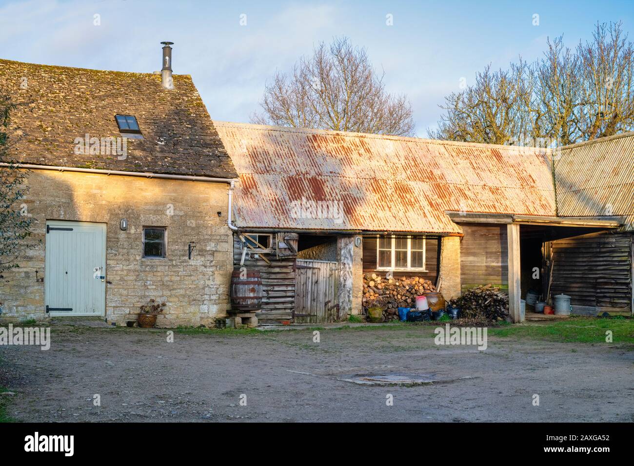 Afternoon winter sunlight on a cotswold house outbuildings in Bledington, Cotswolds, Gloucestershire, England Stock Photo