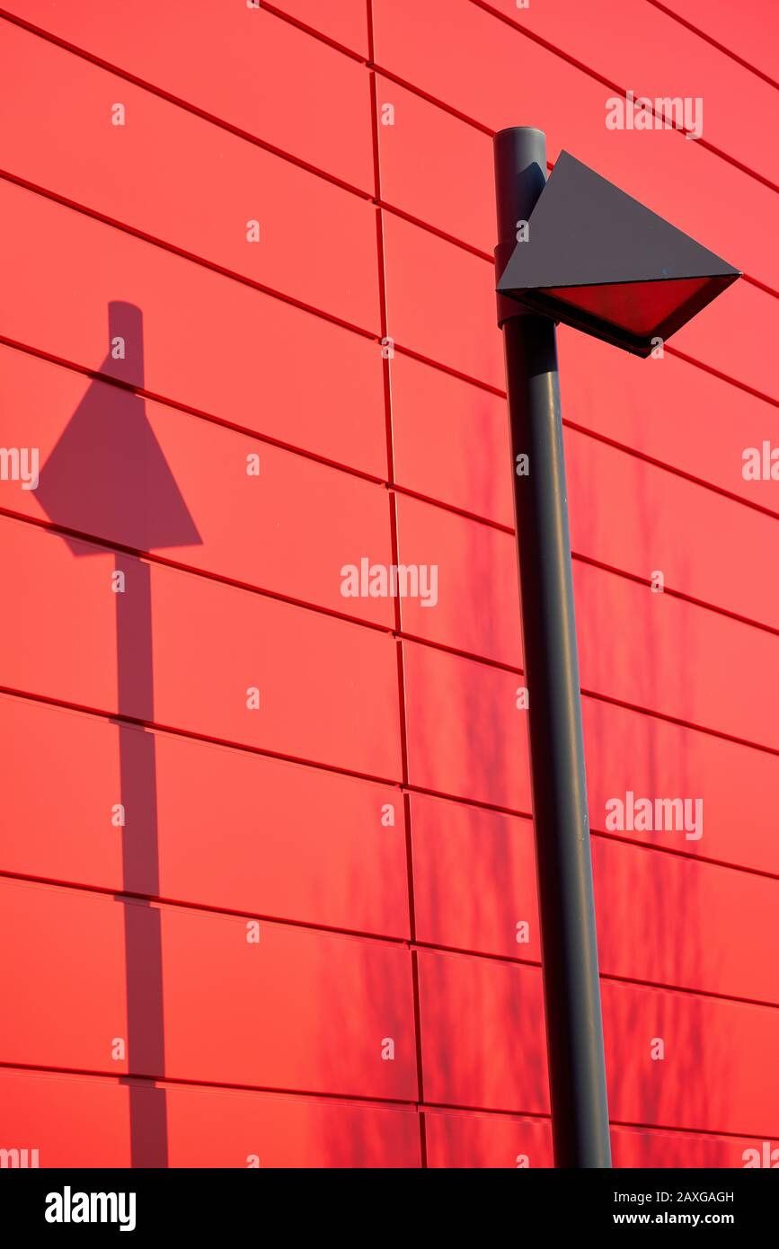 modern lamp on the facade of a red house Stock Photo