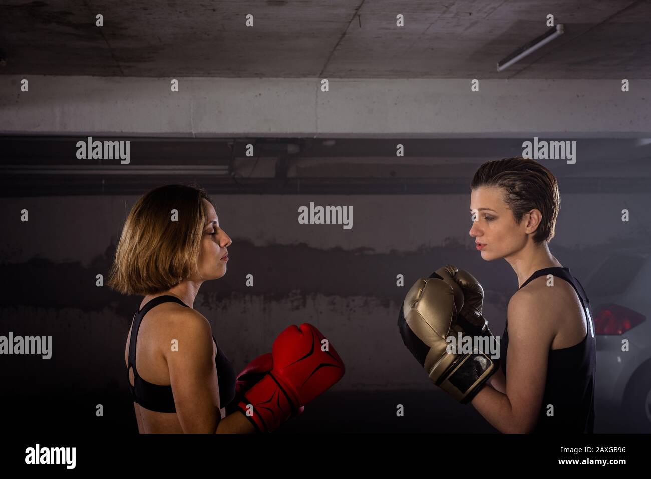 Closeup image of two female boxers with protective equipment