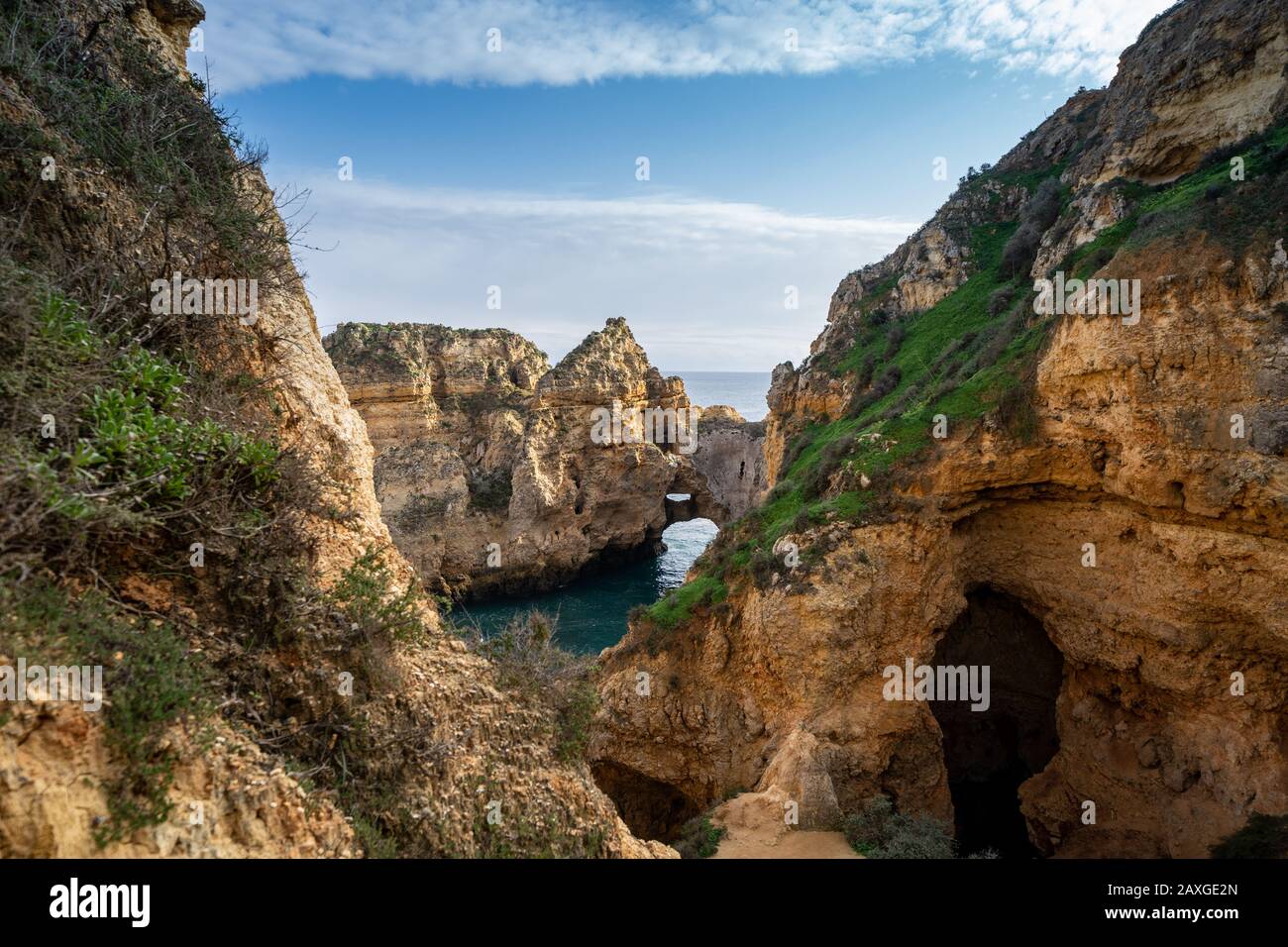 Scenic natural cliff formations and arches of Algarve coastline with ...