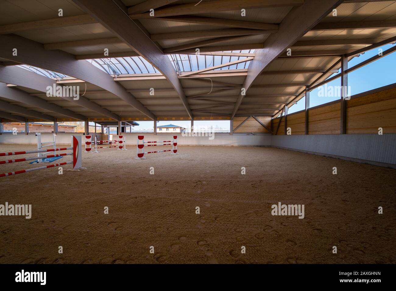 an elaborate roof construction covers a newly built giant riding arena