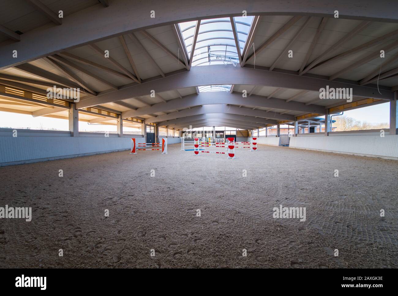 an elaborate roof construction covers a newly built giant riding arena