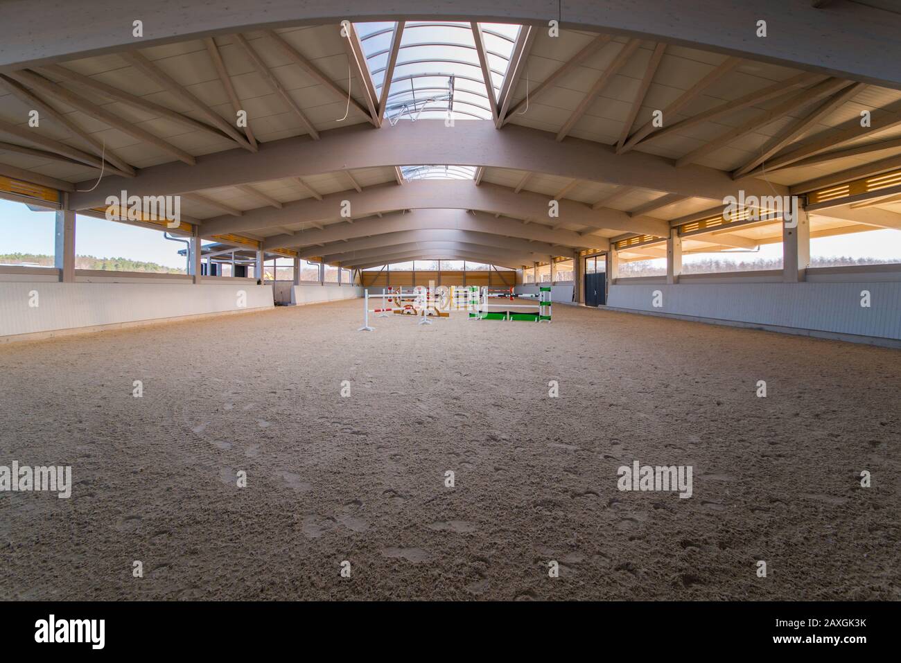an elaborate roof construction covers a newly built giant riding arena