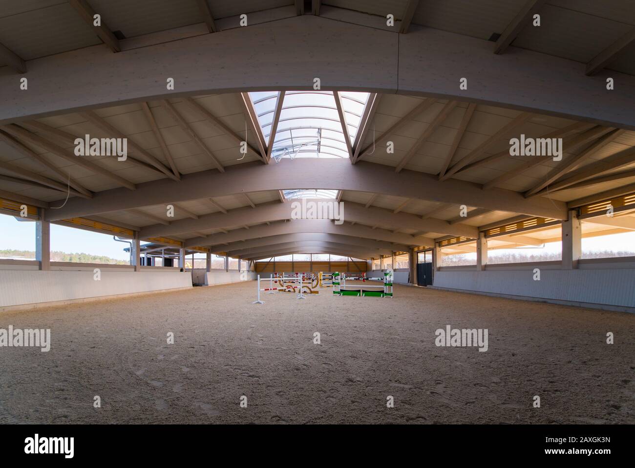 an elaborate roof construction covers a newly built giant riding arena