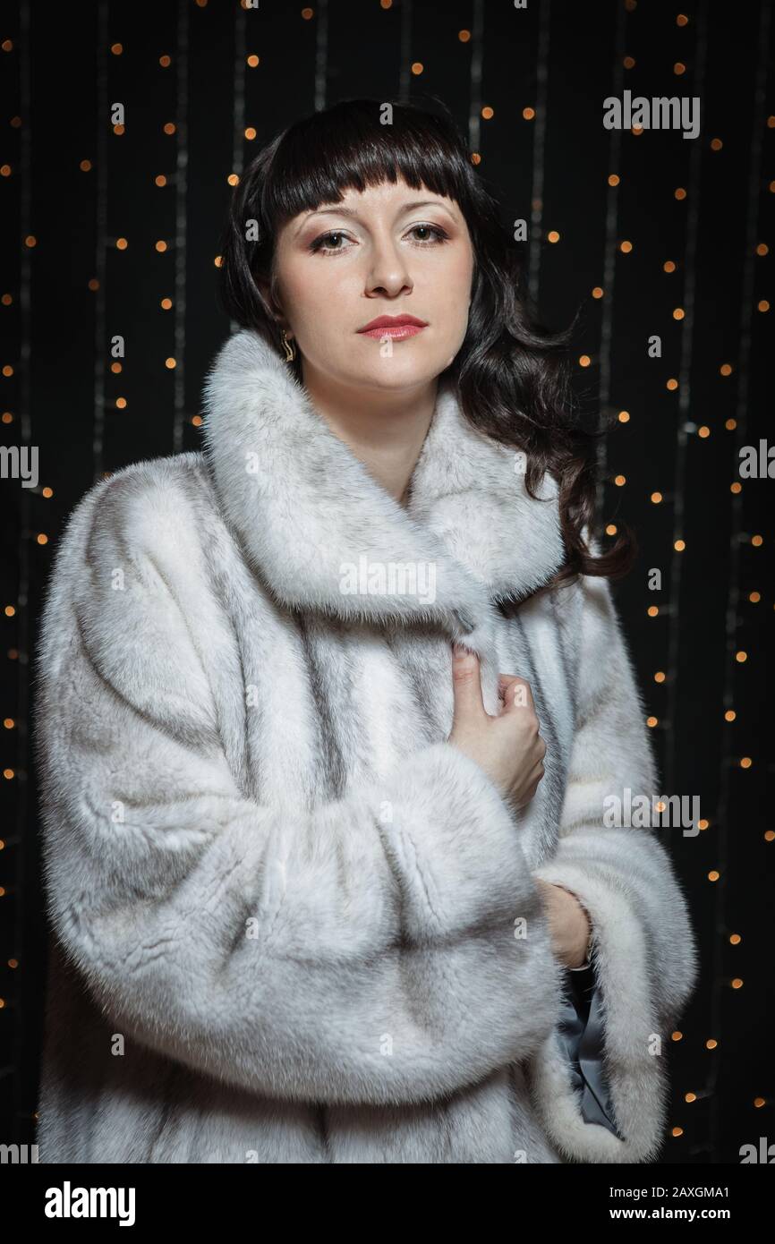 Portrait of beautiful young women in white fur coat Stock Photo - Alamy