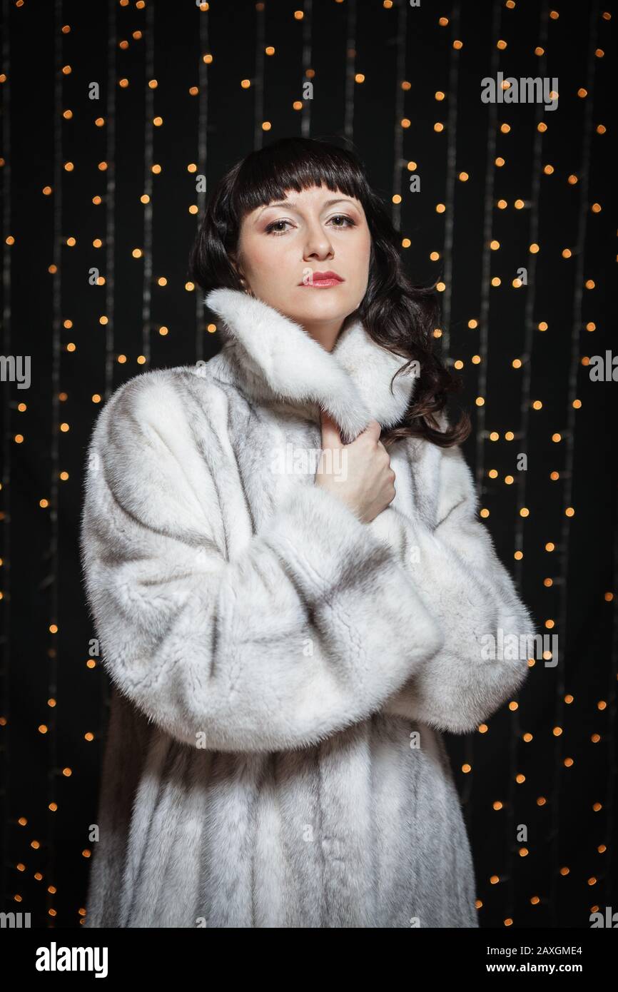 Portrait of beautiful young women in white fur coat Stock Photo - Alamy