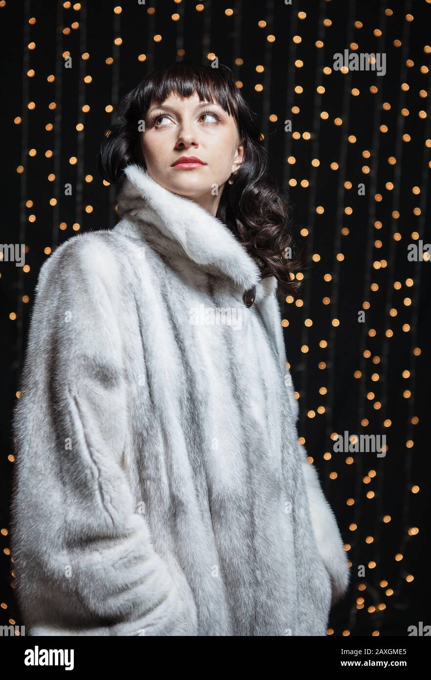 Portrait of beautiful young women in white fur coat Stock Photo - Alamy