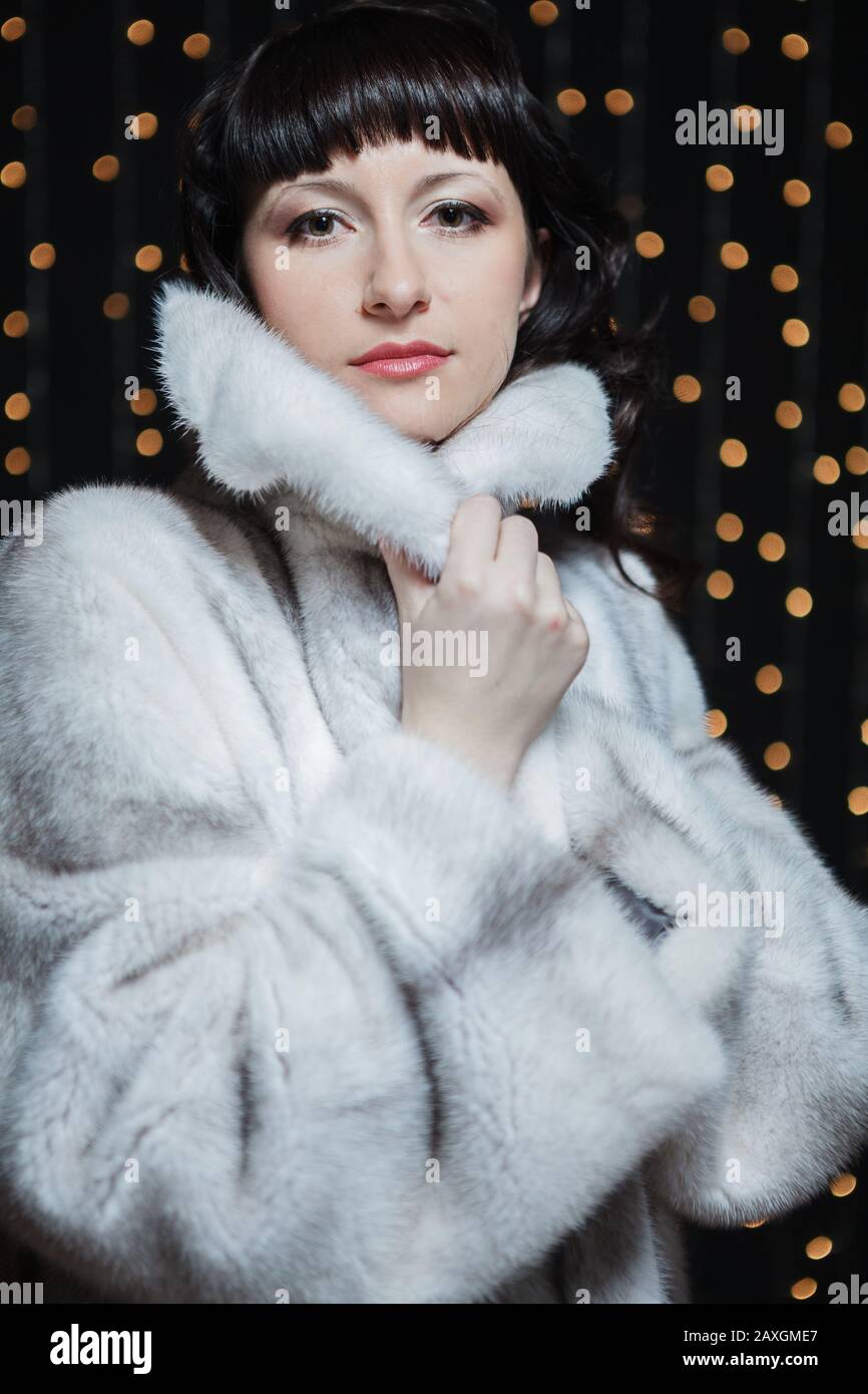 Portrait of beautiful young women in white fur coat Stock Photo - Alamy
