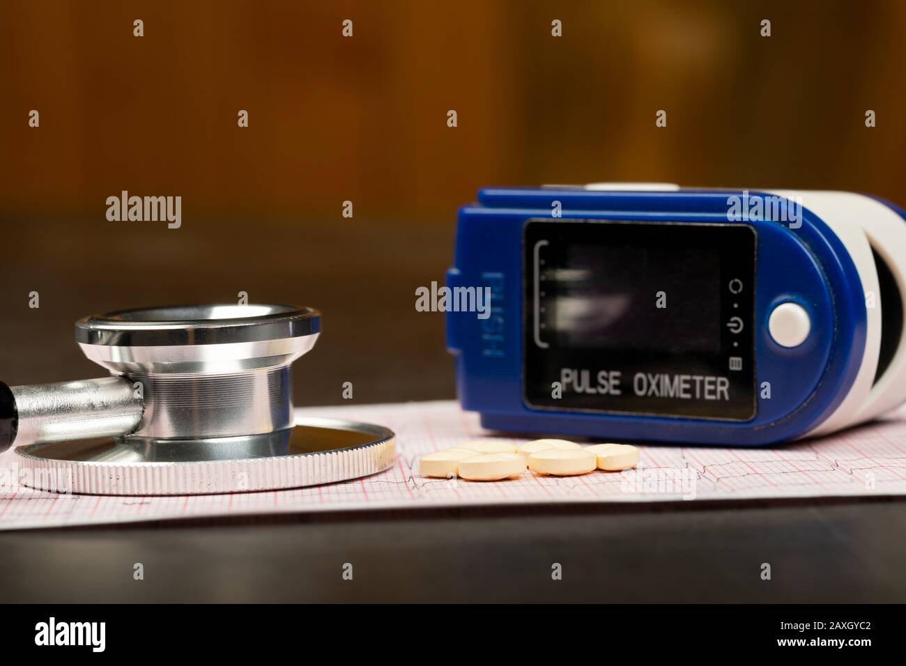 Electrocardiogram graph report with stethoscope and pulse oximeter on it Stock Photo