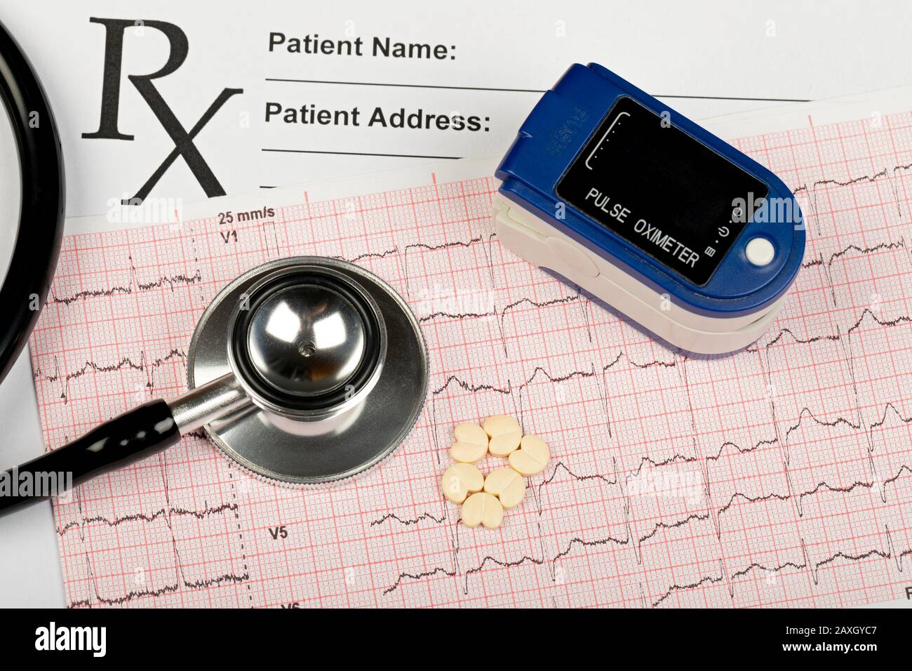 Electrocardiogram graph report with stethoscope and pulse oximeter on it Stock Photo