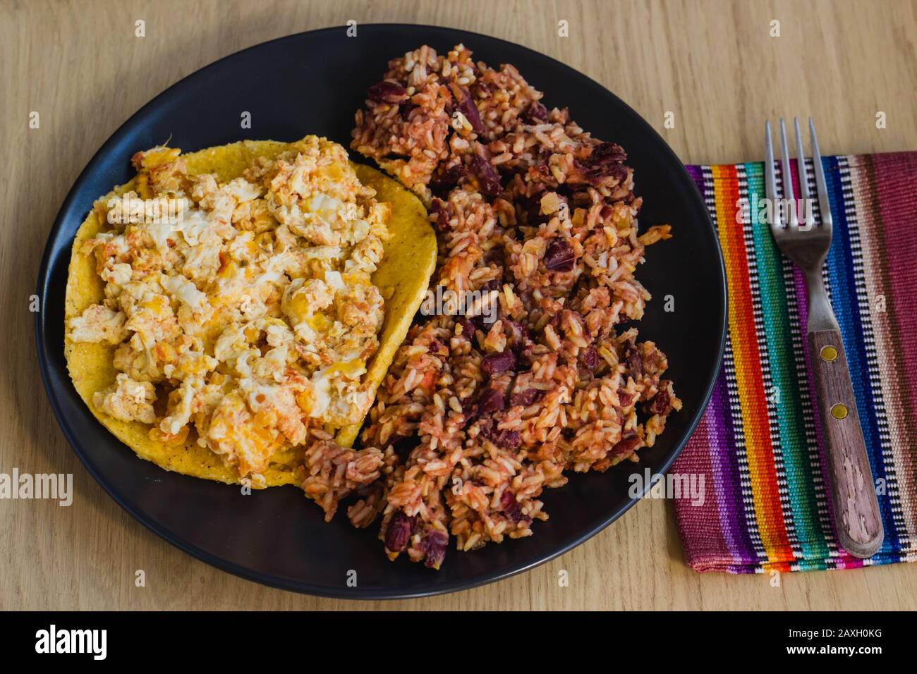 Calentado and huevos pericos con arepa is a traditional breakfast from Colombia made with maize, eggs, rice and black beans Stock Photo