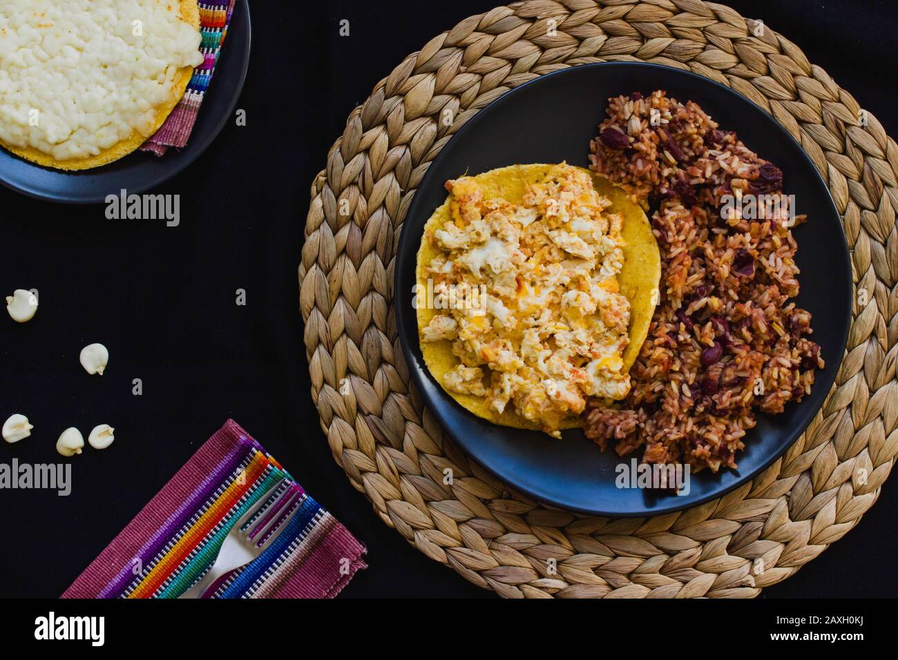 Calentado and huevos pericos con arepa is a traditional breakfast from Colombia made with maize, eggs, rice and black beans Stock Photo
