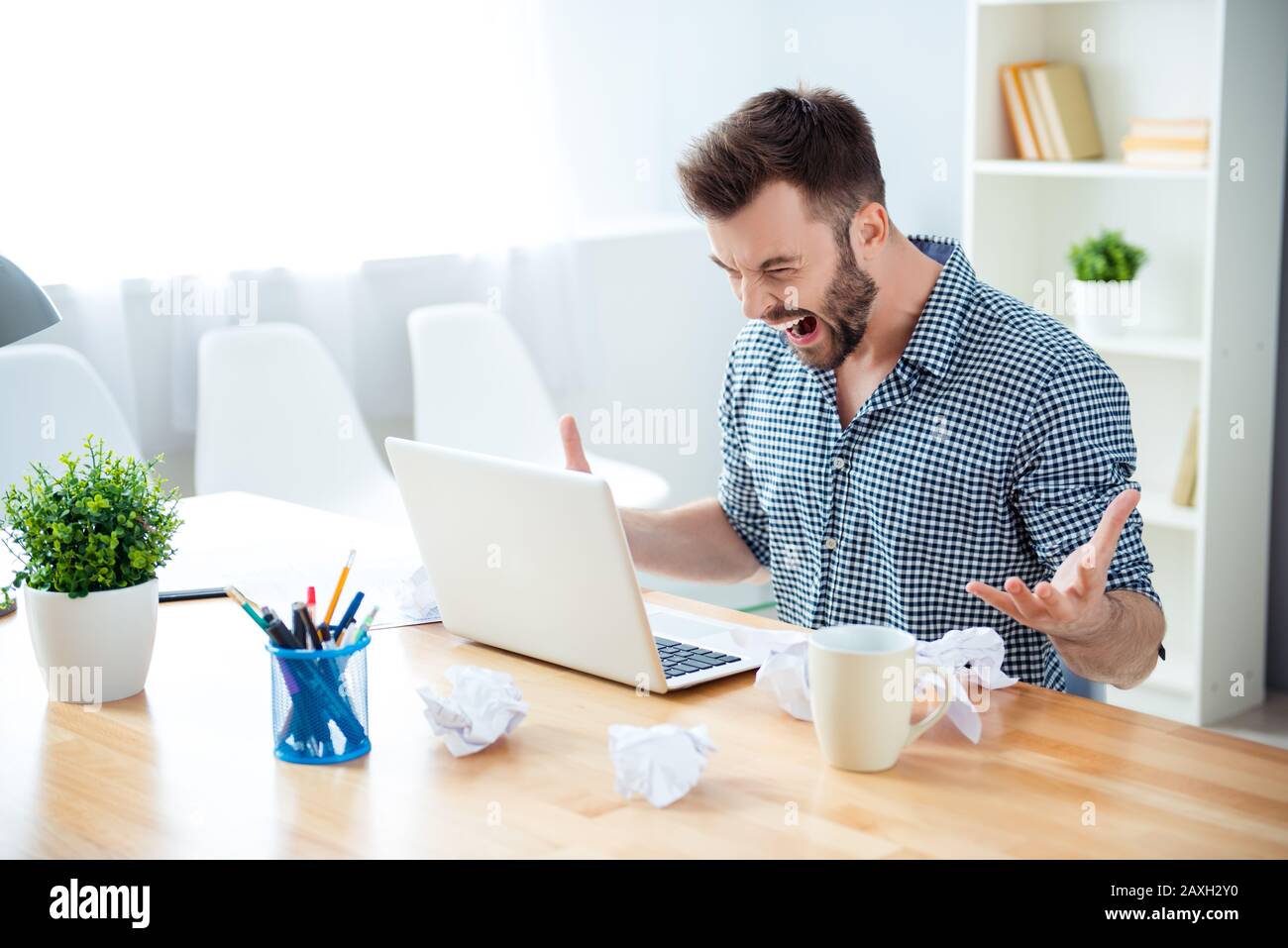 angry man in rage having bad mood screaming in office Stock Photo
