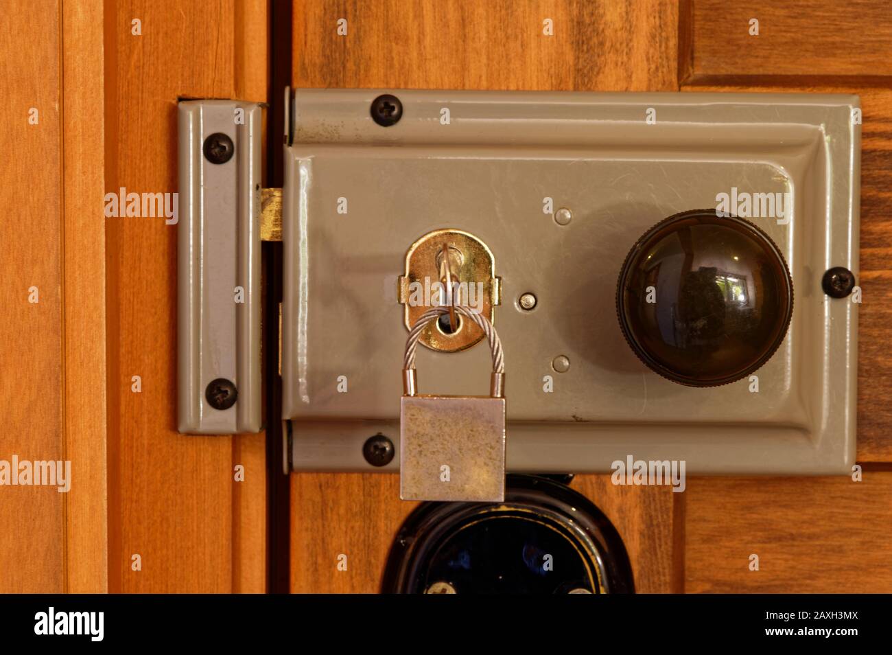 A mortise lock is undone, a key is ready to be turned for security ...