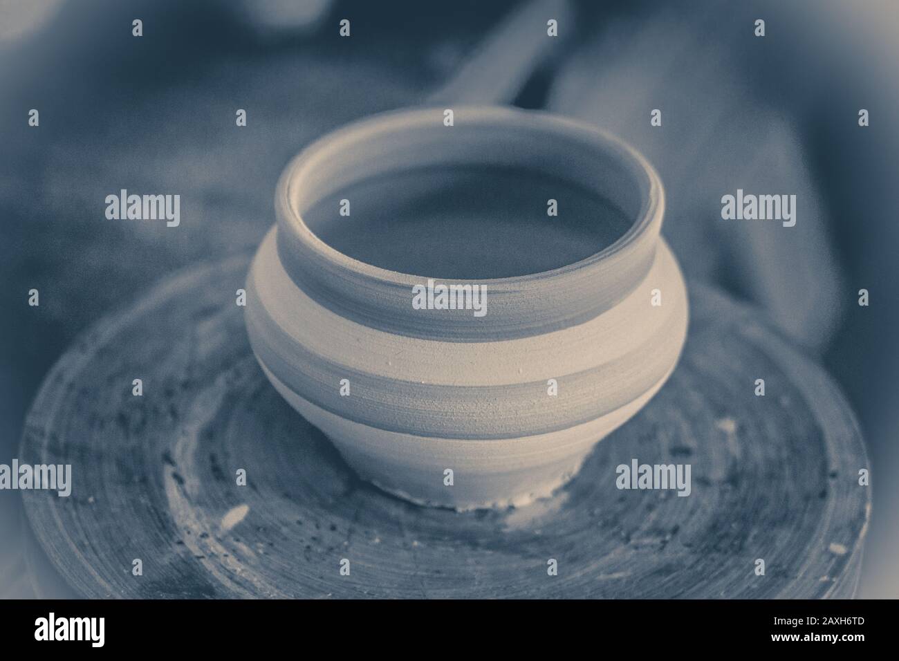 Clay pot on a potter's wheel close-up. Copy spase Stock Photo