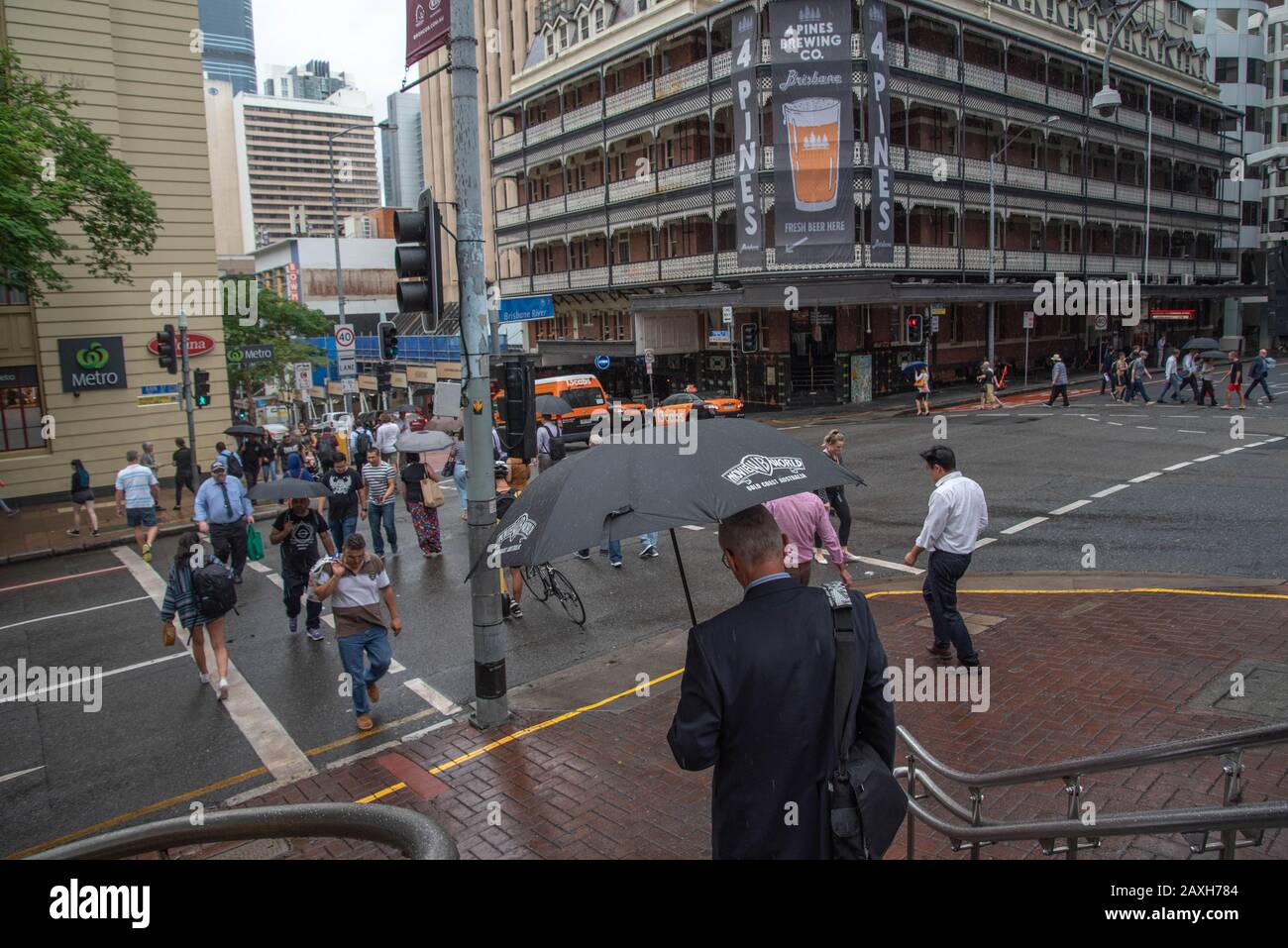 Brisbane, Australia. 12th Feb, 2020. Pedestrians shelter from the rain beneath an umbrella on a rainy in Brisbane.Severe storm hits South East Queensland and Brisbane CBD causing traffic chaos and floods. Credit: SOPA Images Limited/Alamy Live News Stock Photo