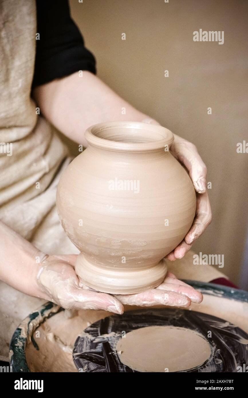 Potter holds just hired by pitcher. Ceramic skills. Sculptor sculpts products from white clay. Workshop pottery.Ukraine, national traditions Stock Photo