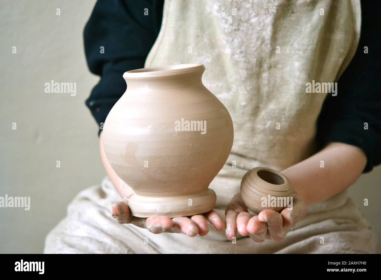 Potter holds just hired by pitcher. Ceramic skills. Sculptor sculpts products from white clay. Workshop pottery.Ukraine, national traditions Stock Photo