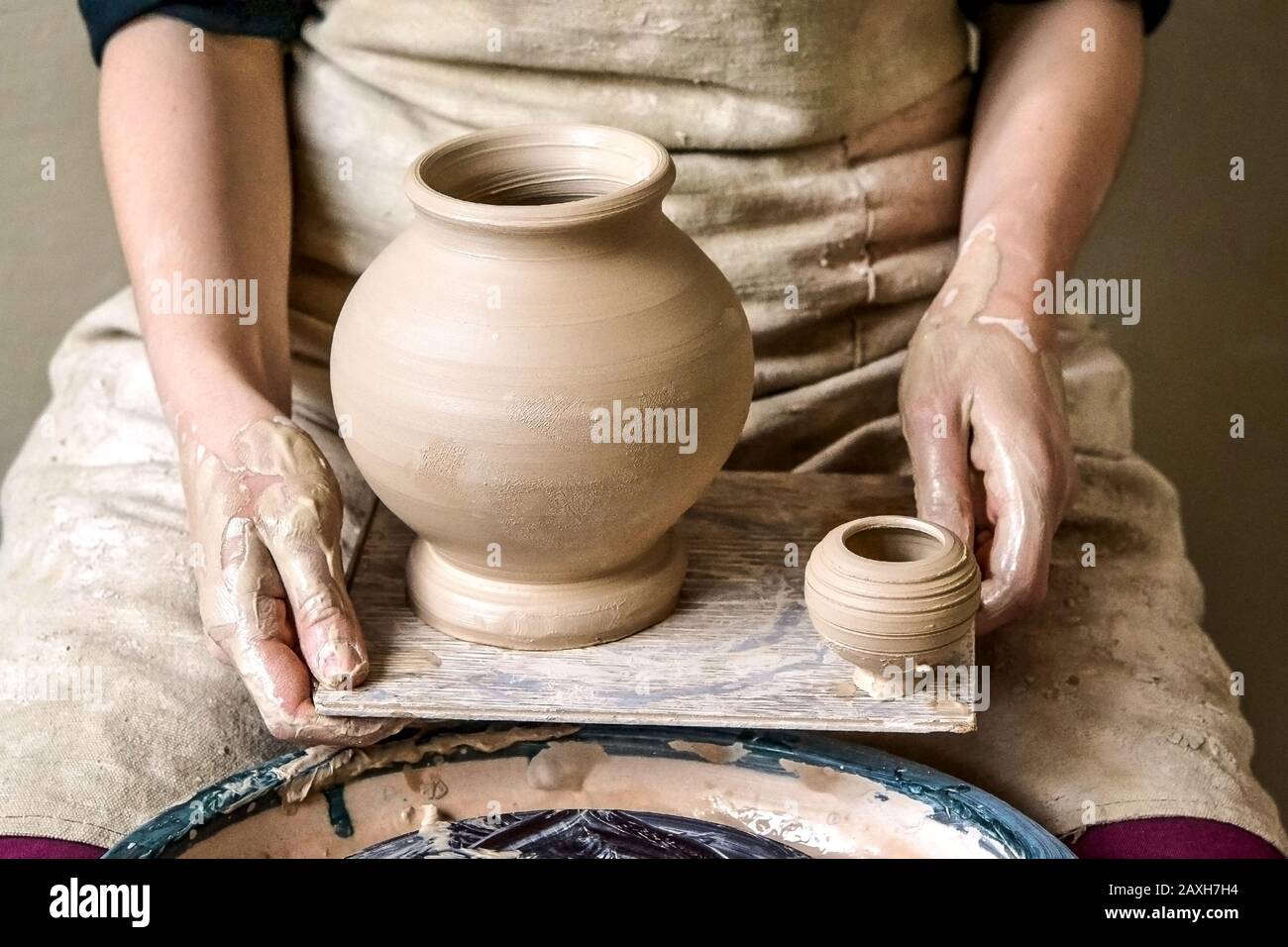 Potter holds just hired by pitchers. Ceramic skills. Sculptor sculpts products from white clay.Workshop pottery. Ukraine, national traditions Stock Photo