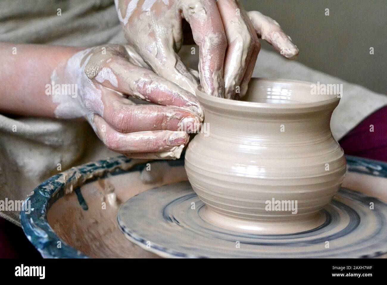 potter making vase from clay. Hands close-up master Stock Photo