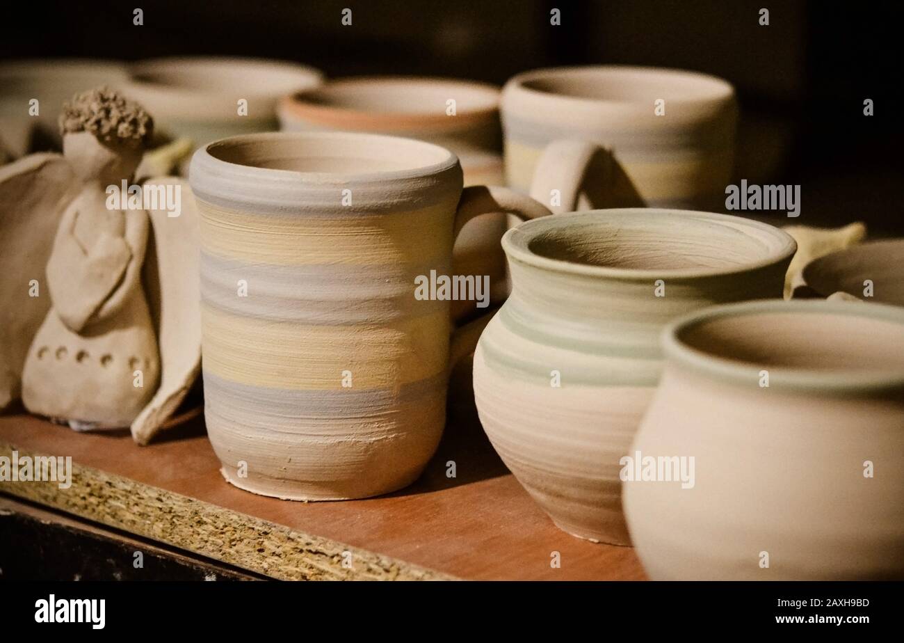 Ceramic clay products stand on the shelf close-up, macro Stock Photo