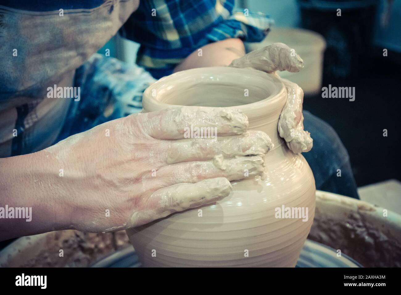 The potter molds clay jug pot closeup. on sculpt white clay