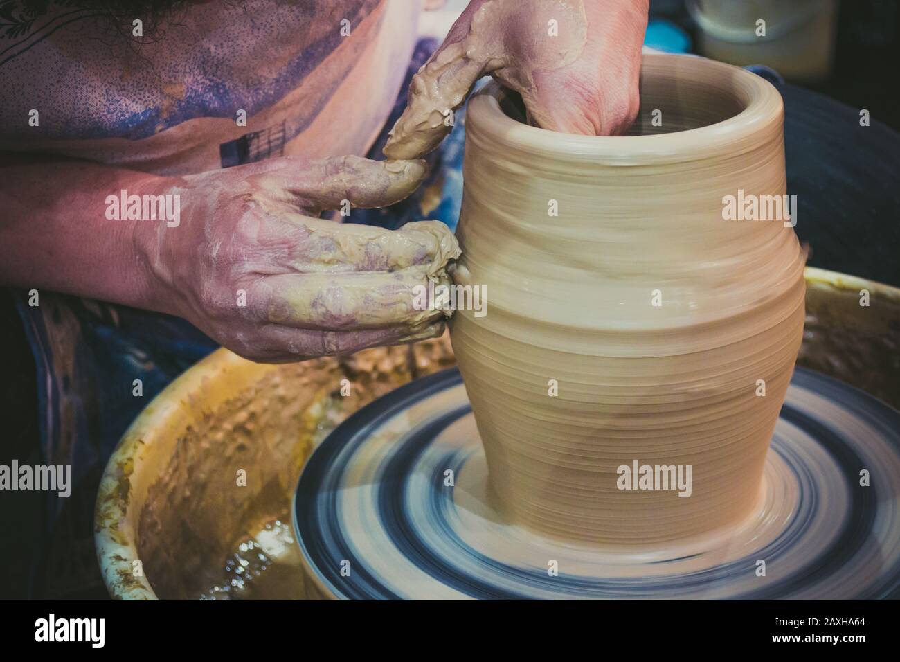 Close-up of woman's hands molding clay on wheel stock photo