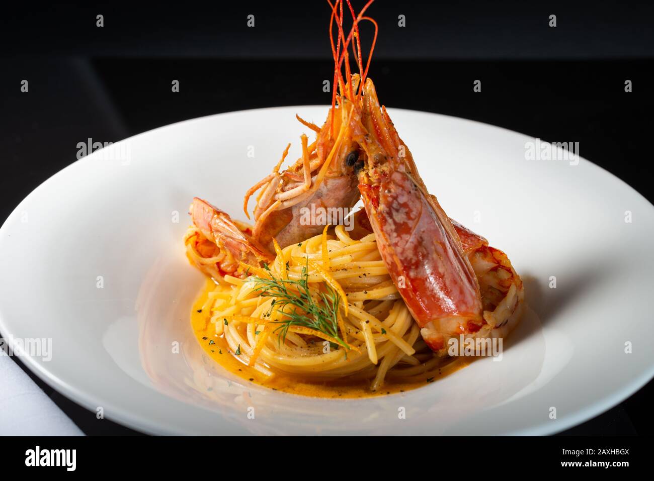 Tiger Prawn Pasta gourmet dish on black background Stock Photo - Alamy