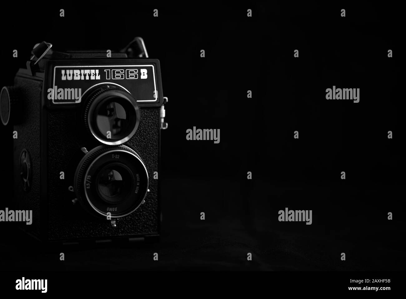 Vintage twin-lens reflex camera, Lubitel 166B, against a dark background. Stock Photo