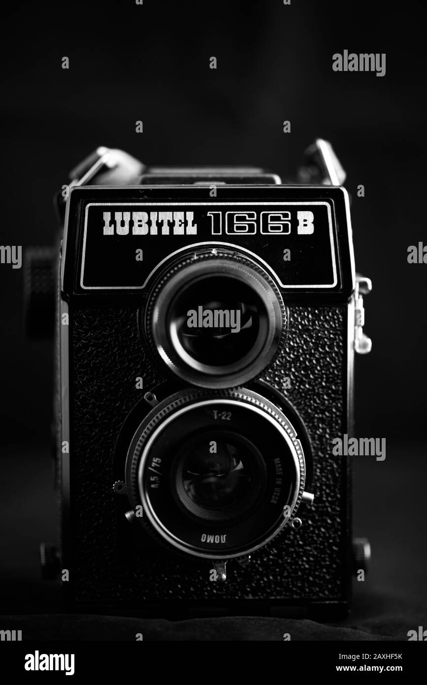 Vintage twin-lens reflex camera, Lubitel 166B, against a dark background. Stock Photo